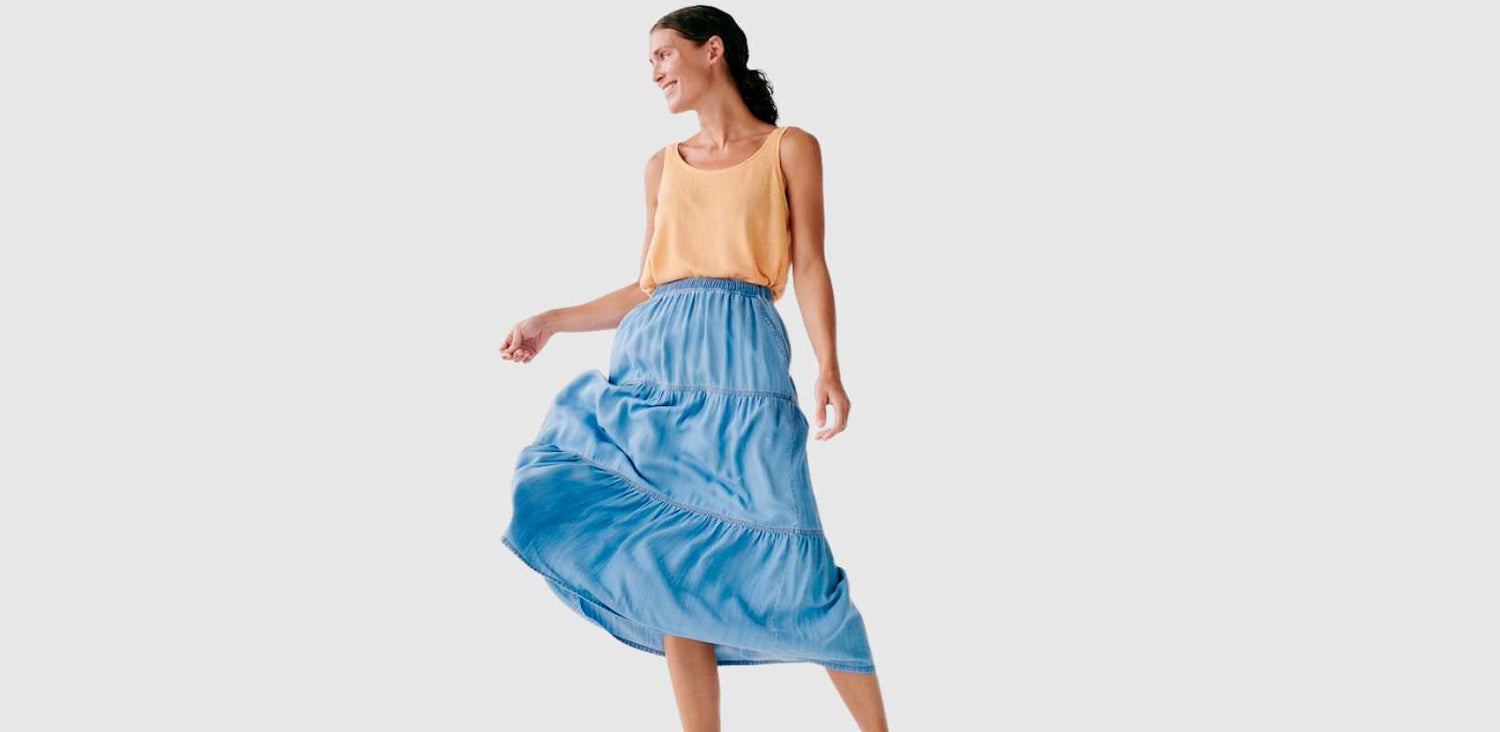 A woman is shown wearing a chambray skirt.