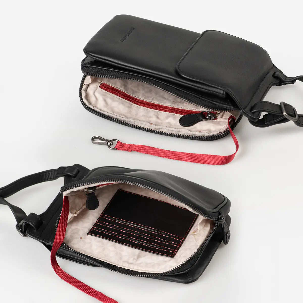 Aunts & Uncles Tulip Leather Phonebag Wallet. Two views of a black leather crossbody phone bag with a red zipper and red strap, shown open on a white background.