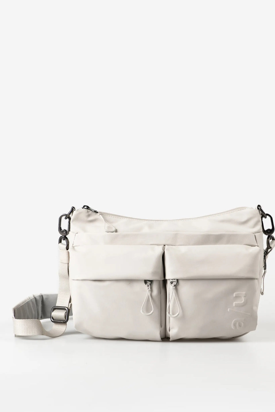 Aunts & Uncles Mogami RE Lite Crossbody Bag. A light beige nylon shoulder bag with multiple front zippered pockets and a detachable shoulder strap, shown against a plain white background.