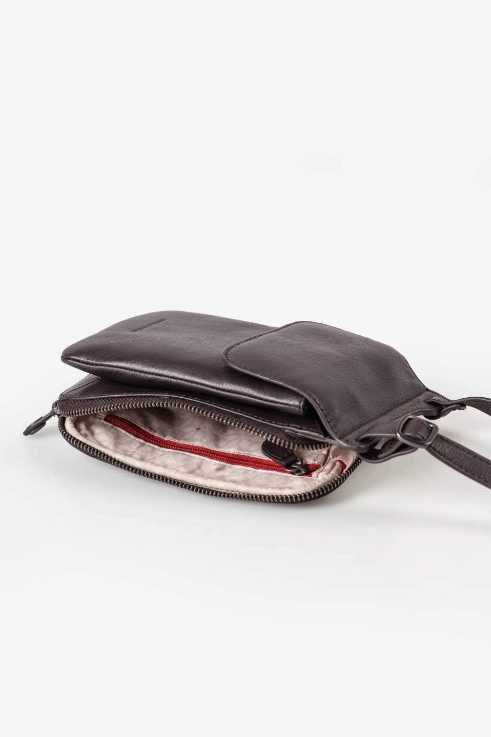 Aunts & Uncles Tulip Leather Phonebag Wallet. A dark brown leather crossbody bag shown open, displaying its interior compartments, zipper, and a light pink lining, set against a plain white background.