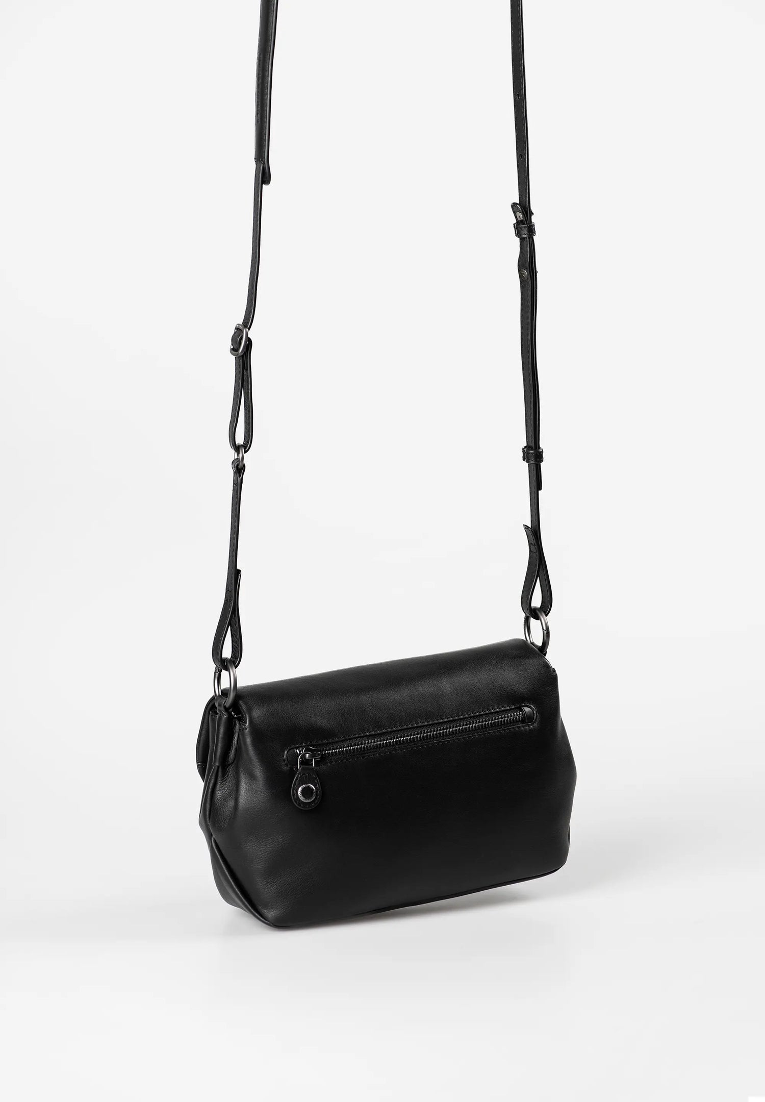 Aunts & Uncles Fern Leather Crossbody Purse. Black leather handbag with a strap on a white background