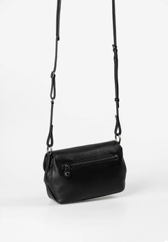 Aunts & Uncles Fern Leather Crossbody Purse. Black leather handbag with a strap on a white background