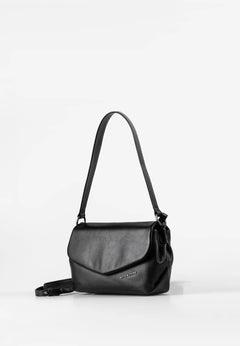 Aunts & Uncles Fern Leather Crossbody Purse. A black leather shoulder bag with a flap front and a long shoulder strap, photographed on a clean white studio background.
