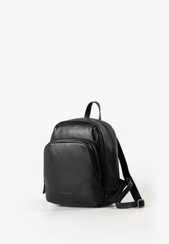 Aunts & Uncles Coco Leather Backpack Purse A black leather backpack with a front zippered pocket and adjustable shoulder strap, photographed on a clean white studio background.