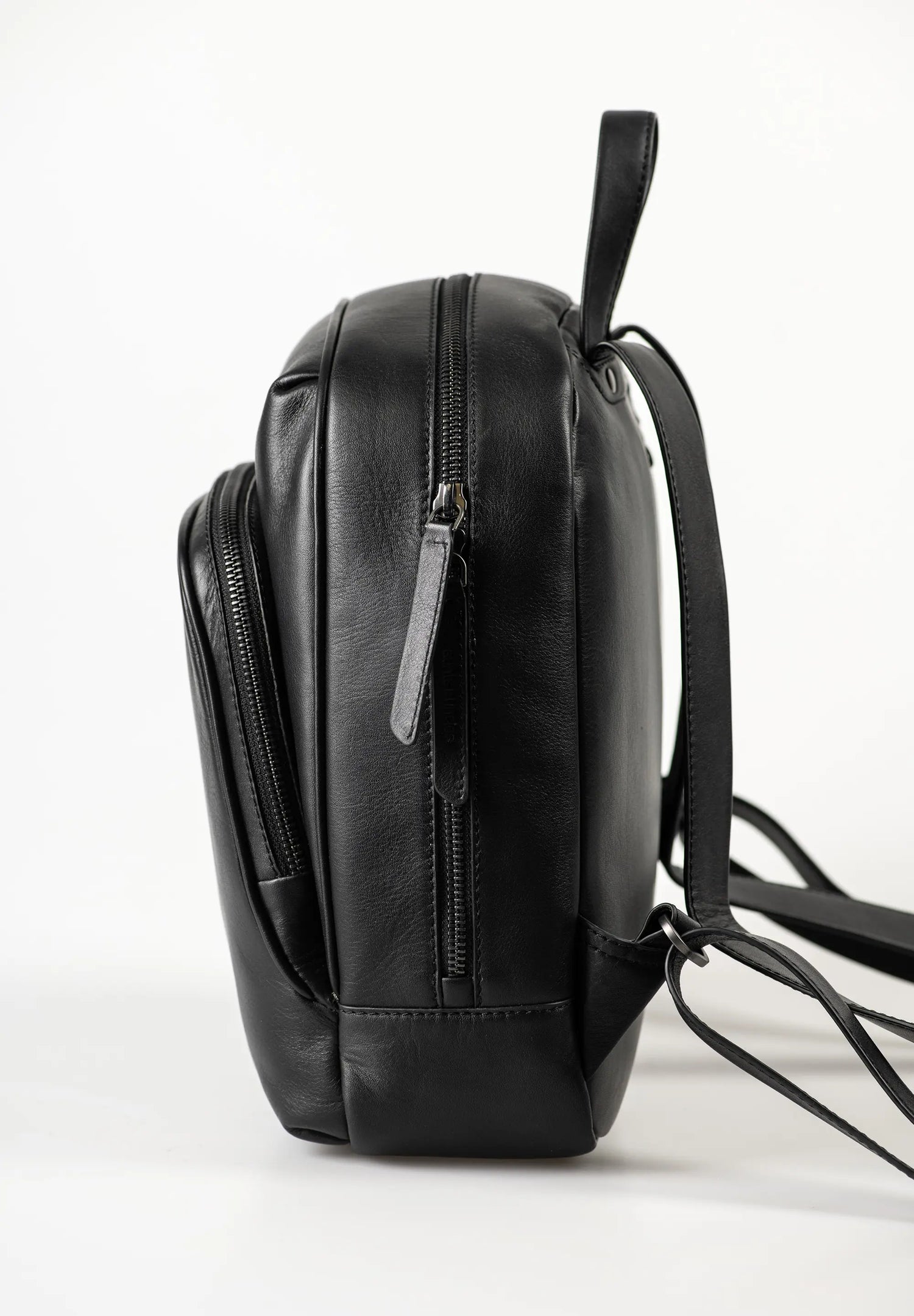 Aunts & Uncles Coco Leather Backpack Purse A black leather backpack shown from a side profile view against a clean white studio background.