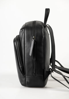 Aunts & Uncles Coco Leather Backpack Purse A black leather backpack shown from a side profile view against a clean white studio background.