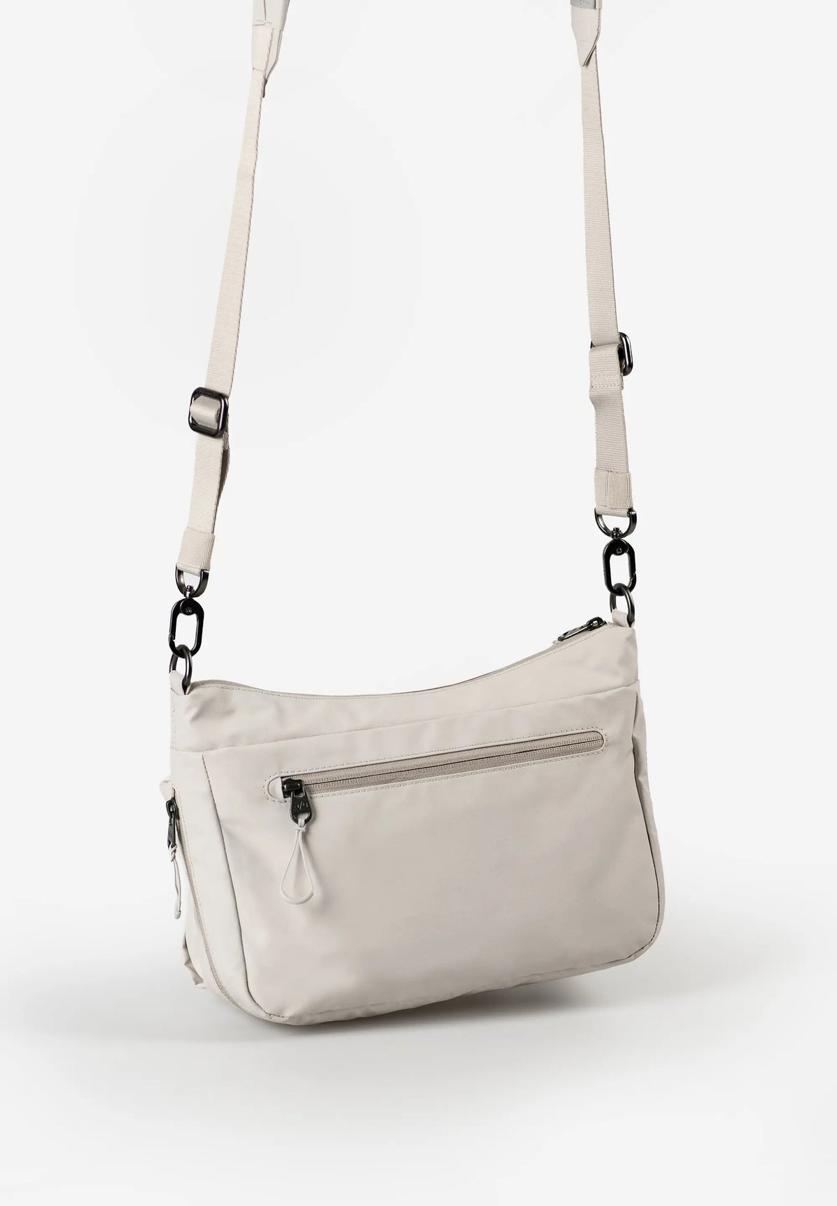 Aunts & Uncles Mogami RE Lite Crossbody Bag. Light gray shoulder bag with straps on a white background