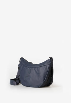 Aunts & Uncles Toyo RE Lite Halfmoon Bag. A navy blue crescent-shaped shoulder bag with a matching adjustable strap, displayed on a clean white background.