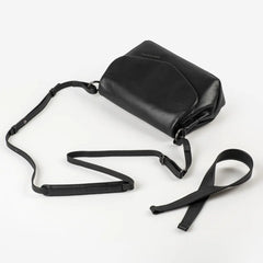 Aunts & Uncles Fern Leather Crossbody Purse. A black leather crossbody bag with a long adjustable strap, displayed on a clean white background.