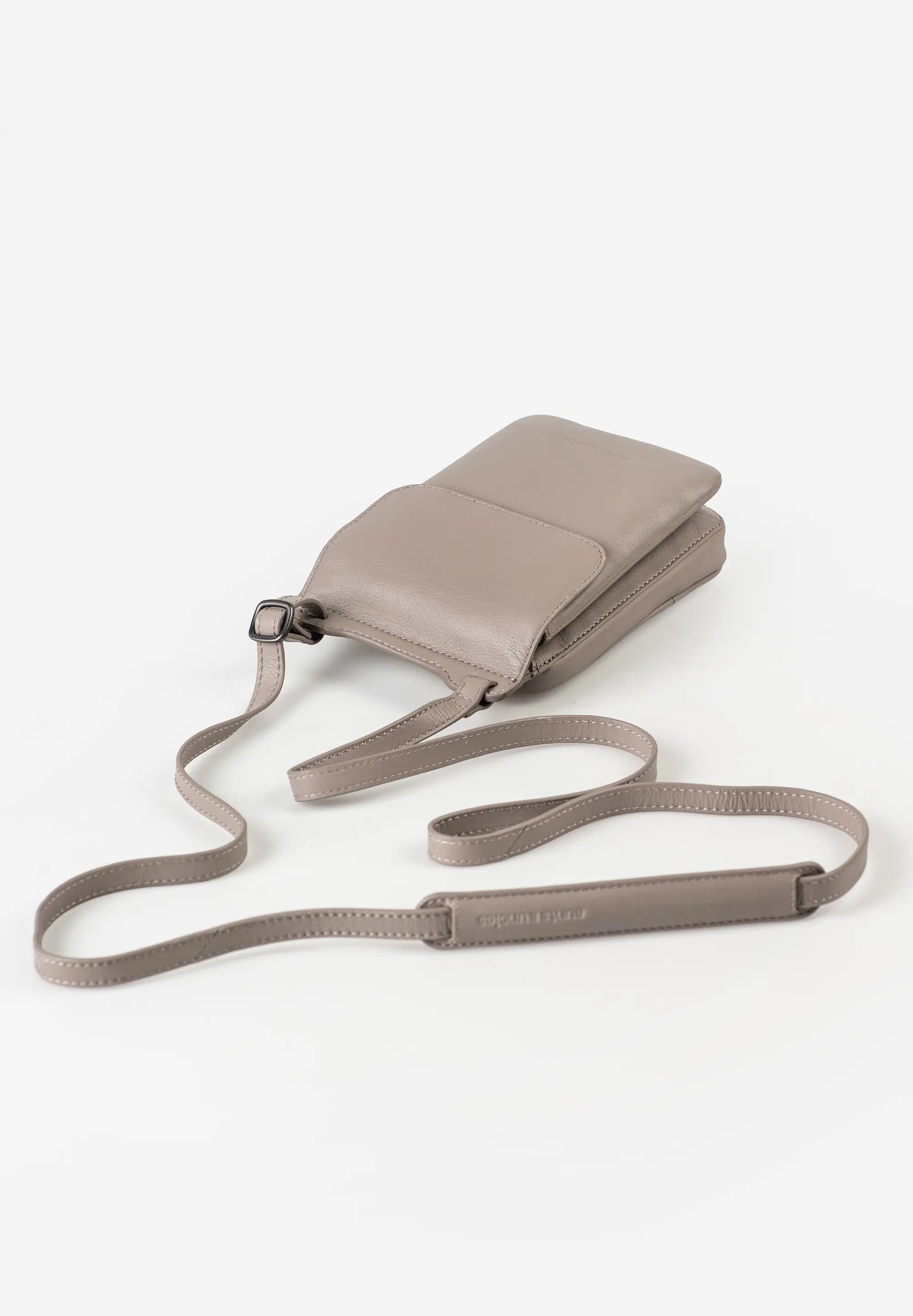Aunts & Uncles Tulip Leather Phonebag Wallet. A taupe leather crossbody phone bag with a matching adjustable shoulder strap, displayed on a clean white background.