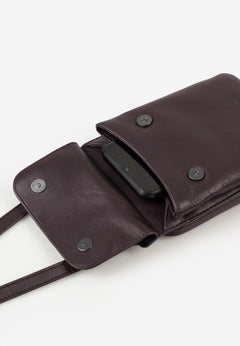 Aunts & Uncles Tulip Leather Phonebag Wallet. A dark brown leather crossbody bag shown open, revealing a black smartphone tucked inside a side pocket. The bag features a strap and snap-button closures on a clean white background.