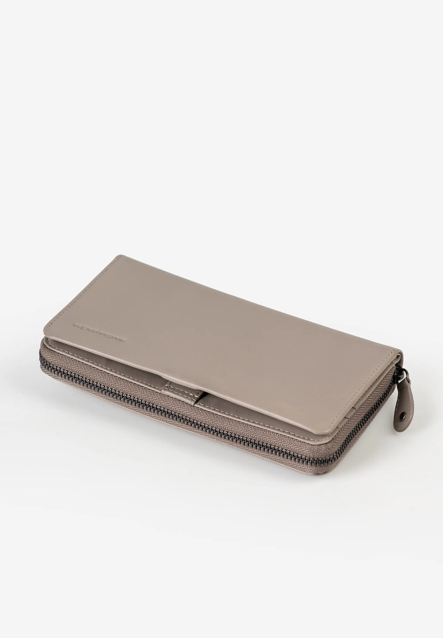 Aunts & Uncles Maple Leather Wallet. A taupe leather zip-around wallet with a fold-over flap and a small leather pull tab, photographed on a clean white background.