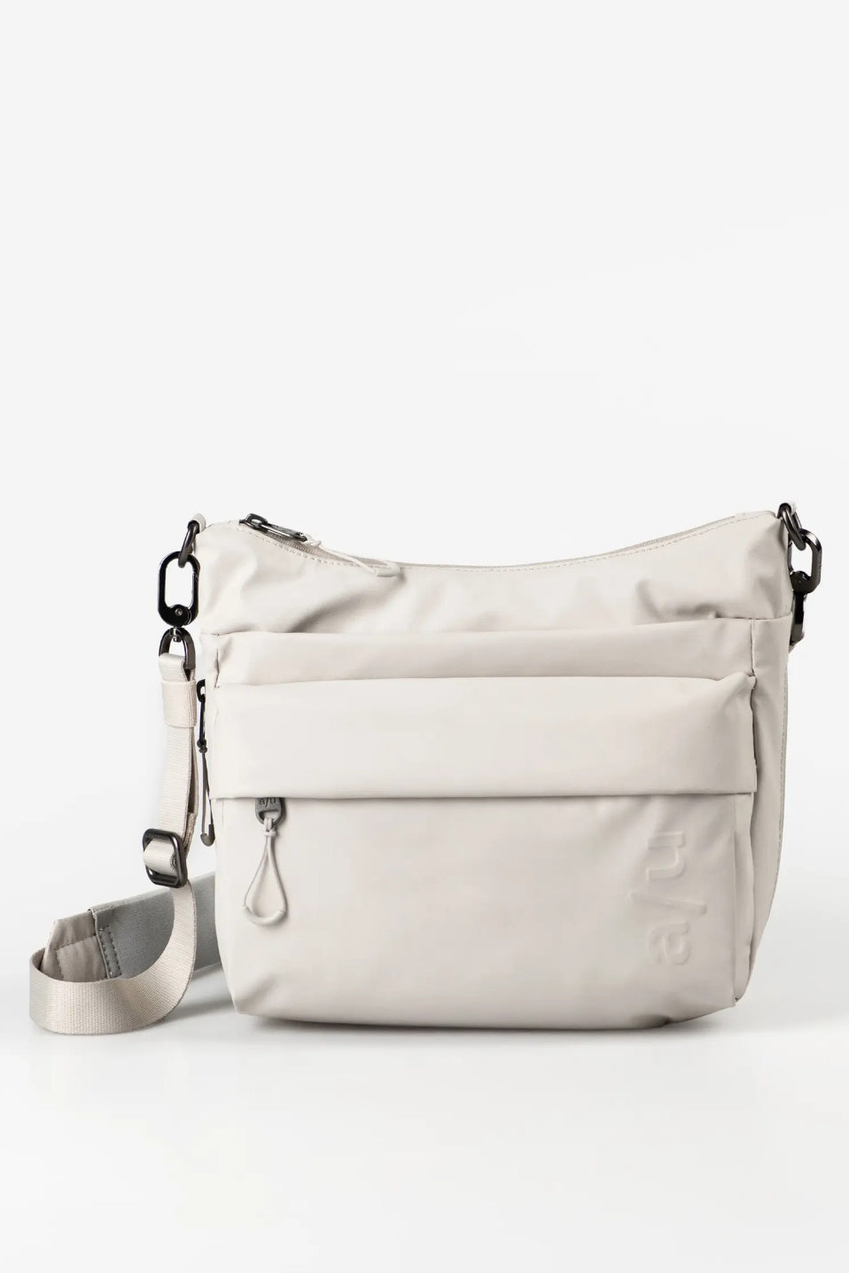 Aunts & Uncles Nanuki RE Lite Crossbody Bag. A light beige nylon shoulder bag with a front zippered pocket and a matching adjustable shoulder strap, shown on a clean white background.