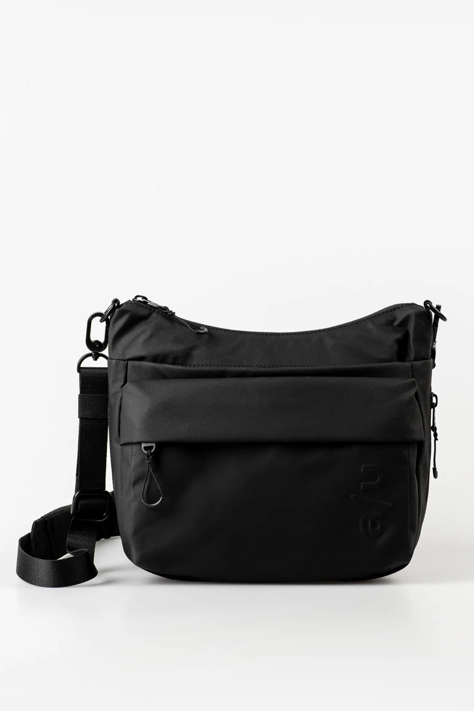 Aunts & Uncles Nanuki RE Lite Crossbody Bag. A black nylon shoulder bag with a front zippered pocket and an adjustable shoulder strap, shown on a clean white background.