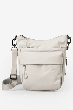 Aunts & Uncles Yura RE Lite Crossbody Bag.A light beige nylon shoulder bag with a front flap pocket, side zipper, and adjustable shoulder strap, shown on a clean white background.